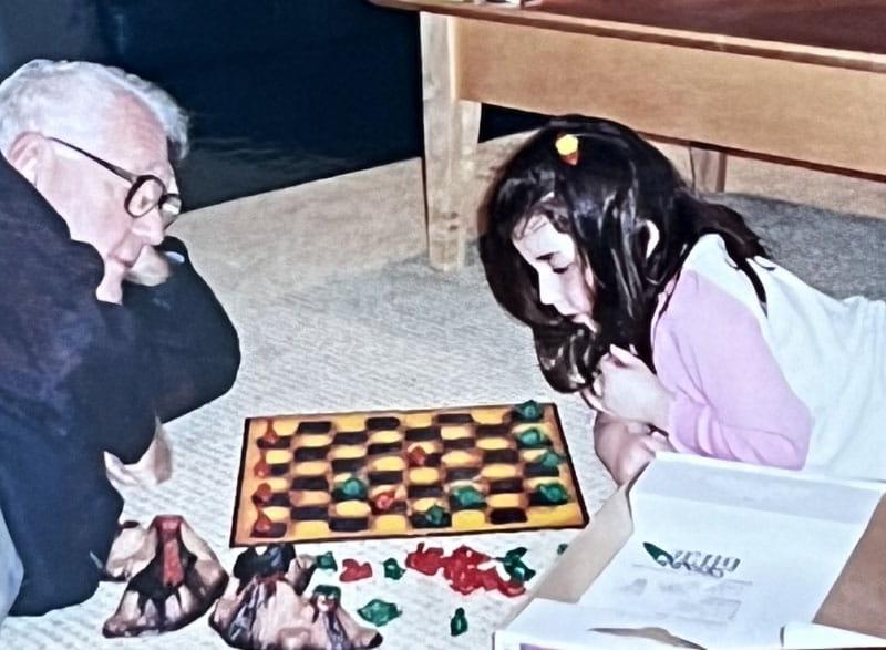 Dr. Eugene Braunwald plays a game of Dino checkers with his granddaughter Rachel in 2003. (Photo courtesy of the Braunwald family)